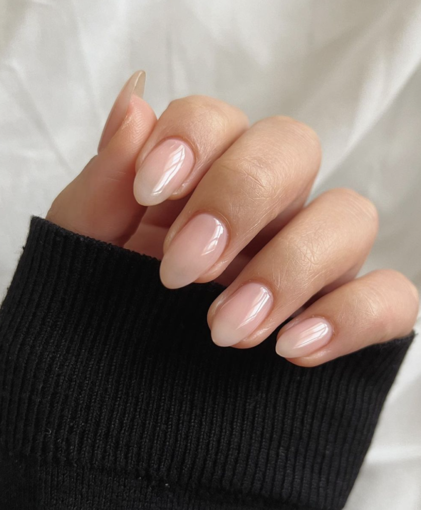 Close-up of nails with a natural nude finish.